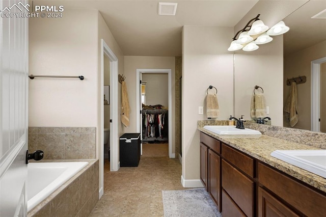 full bathroom featuring double vanity, tiled bath, visible vents, toilet, and a sink