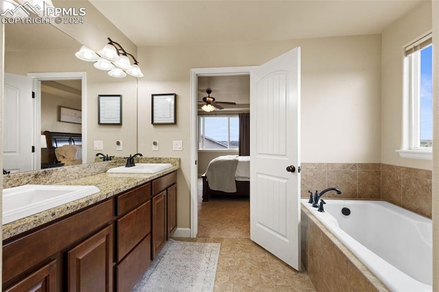 ensuite bathroom featuring a wealth of natural light, ensuite bath, and a sink