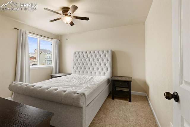 bedroom featuring light carpet, ceiling fan, and baseboards