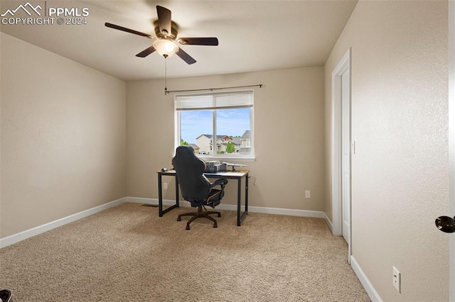 carpeted office featuring ceiling fan and baseboards