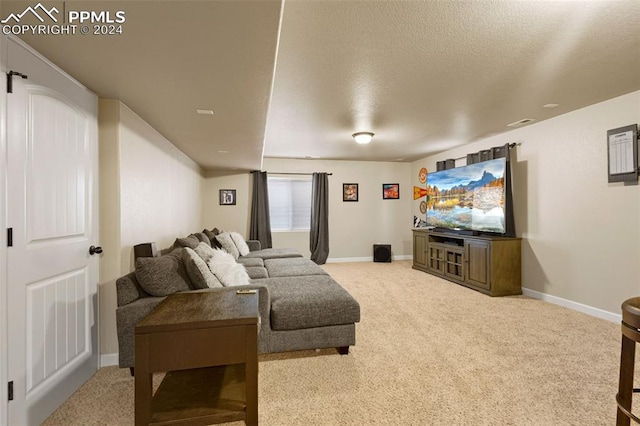 carpeted home theater room with baseboards and a textured ceiling