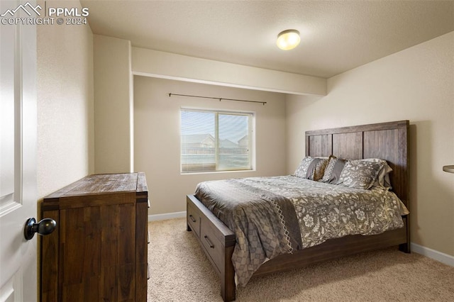 bedroom with light carpet and baseboards