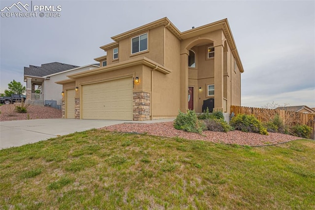 view of front of home featuring fence, driveway, stone siding, stucco siding, and a front lawn