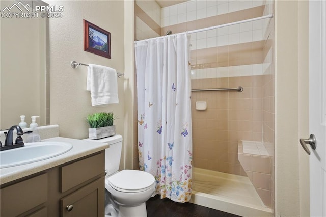 bathroom with vanity, hardwood / wood-style flooring, toilet, and curtained shower