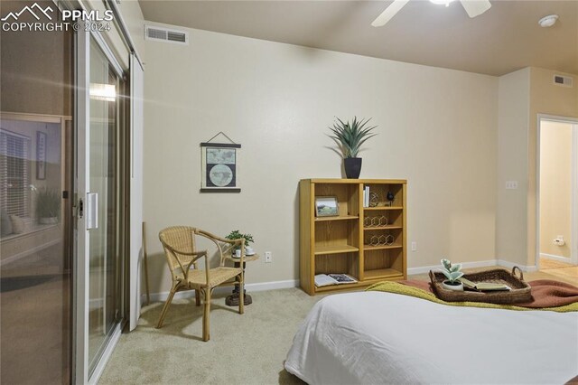 bedroom with ceiling fan and light carpet