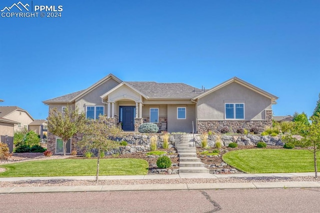 craftsman-style house with a front lawn