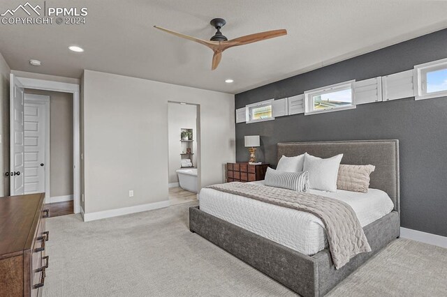 carpeted bedroom featuring ensuite bath and ceiling fan