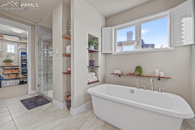 bathroom featuring independent shower and bath