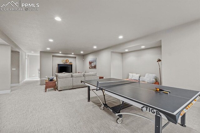 rec room with light colored carpet
