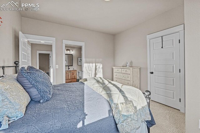 carpeted bedroom featuring ensuite bathroom
