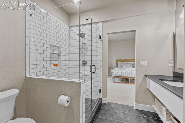 bathroom featuring vanity, tile patterned flooring, toilet, and walk in shower