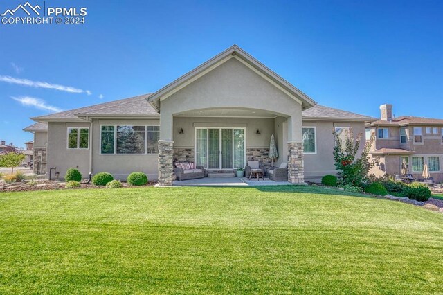 back of house with a yard and a patio area
