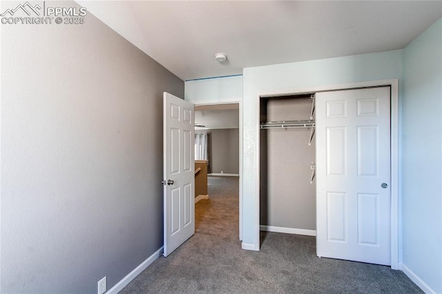 unfurnished bedroom featuring carpet flooring and a closet