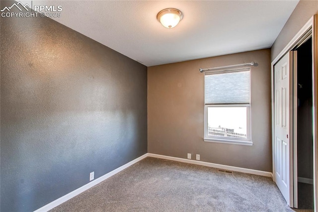 unfurnished bedroom featuring carpet flooring and a closet