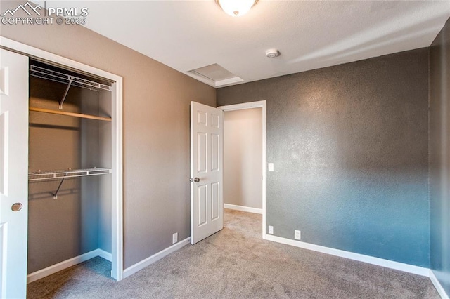 unfurnished bedroom with light colored carpet and a closet