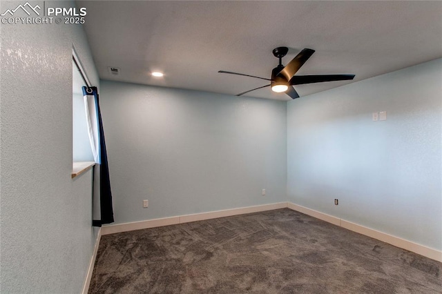 carpeted spare room featuring ceiling fan