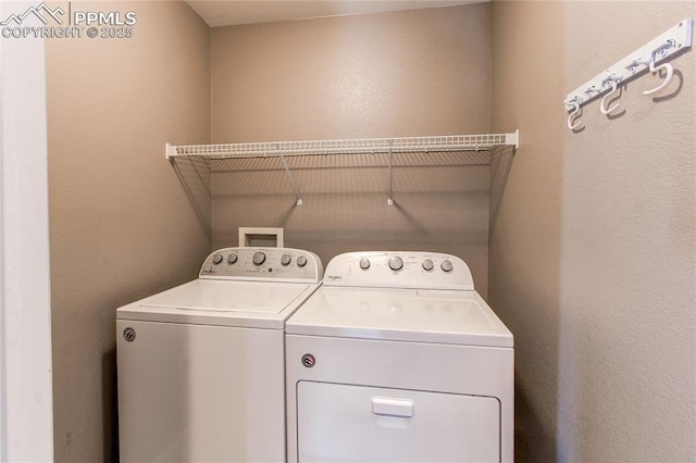 laundry area with washing machine and clothes dryer