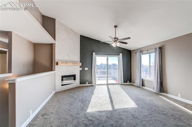 unfurnished living room featuring light carpet, ceiling fan, lofted ceiling, and a tiled fireplace