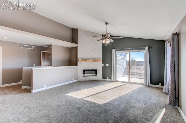 unfurnished living room with a fireplace, carpet floors, vaulted ceiling, and ceiling fan