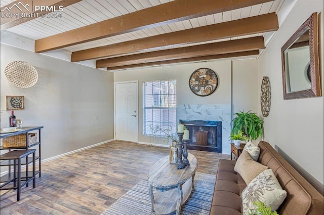 living room featuring a fireplace, hardwood / wood-style floors, and beam ceiling