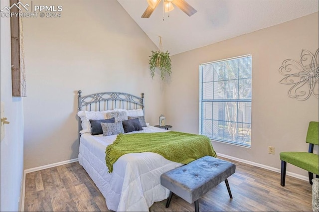 bedroom featuring hardwood / wood-style flooring, ceiling fan, and lofted ceiling