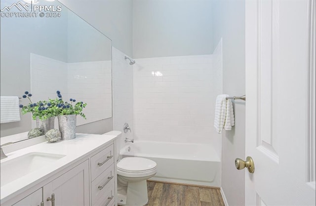 full bathroom featuring hardwood / wood-style floors, vanity, toilet, and shower / bath combination