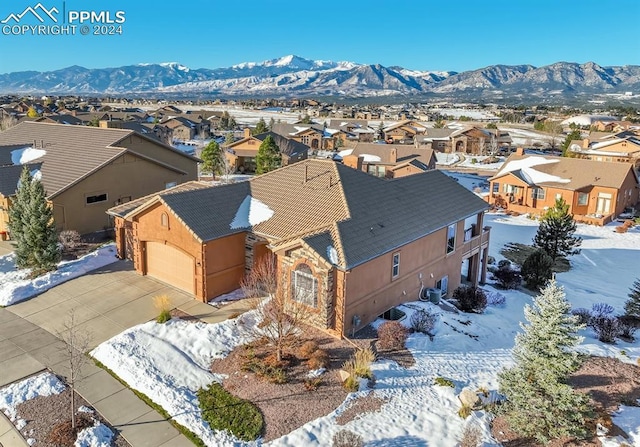 snowy aerial view featuring a mountain view