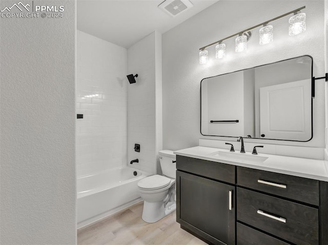 full bathroom with hardwood / wood-style flooring, vanity, toilet, and bathing tub / shower combination