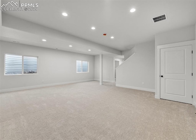 basement featuring light colored carpet