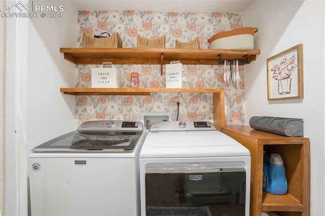 clothes washing area featuring washer and clothes dryer