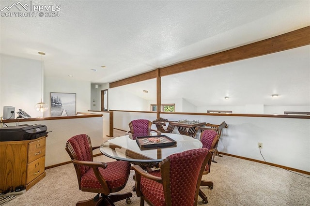 carpeted dining area with a textured ceiling and lofted ceiling