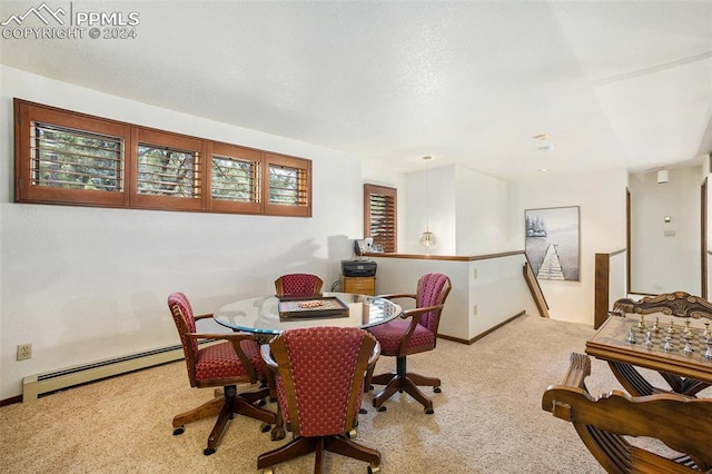 dining area with baseboard heating and light carpet