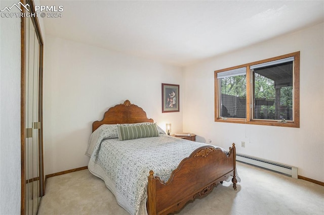 bedroom featuring baseboard heating and light colored carpet