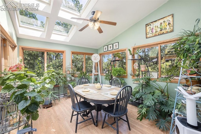 sunroom / solarium featuring ceiling fan and vaulted ceiling with skylight