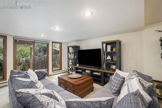 living room featuring a textured ceiling and a baseboard heating unit