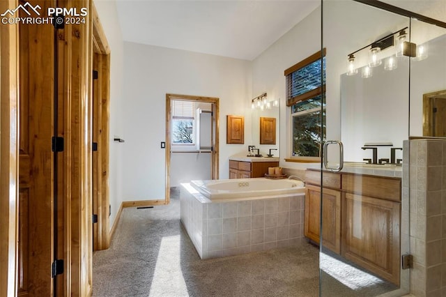 bathroom featuring vanity and shower with separate bathtub