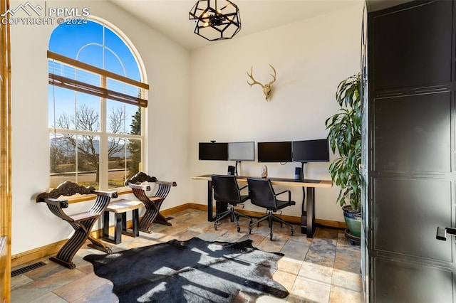 home office featuring a notable chandelier and plenty of natural light