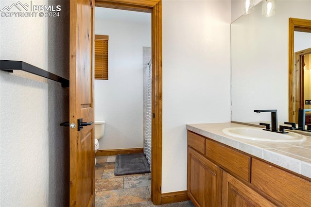 bathroom featuring vanity and toilet