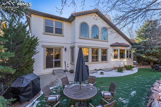 rear view of house with a yard and a patio area