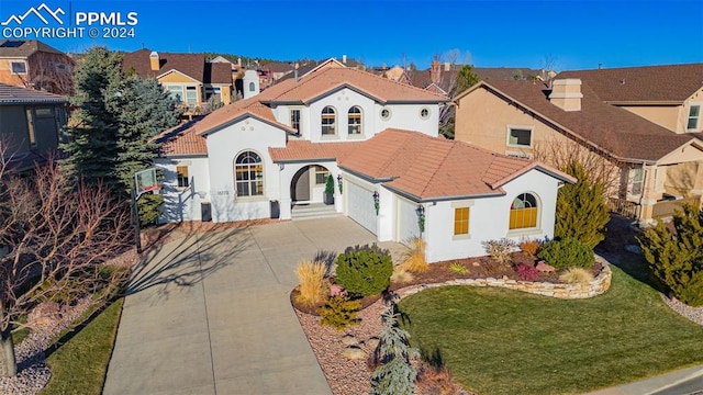 mediterranean / spanish-style house with a front lawn