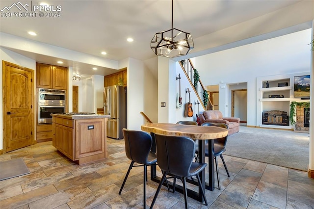 dining space featuring carpet flooring, a chandelier, and built in features