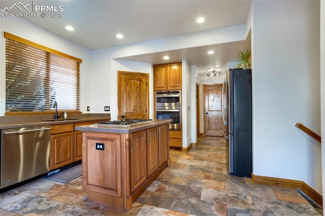 kitchen featuring a center island, sink, and stainless steel appliances