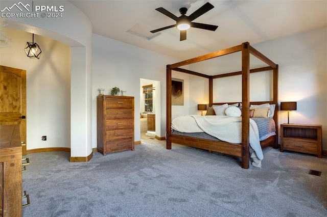 unfurnished bedroom with carpet flooring, ensuite bathroom, and ceiling fan