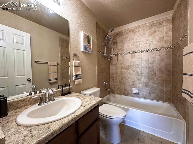 full bath with a textured wall, bathtub / shower combination, toilet, vanity, and tile patterned floors