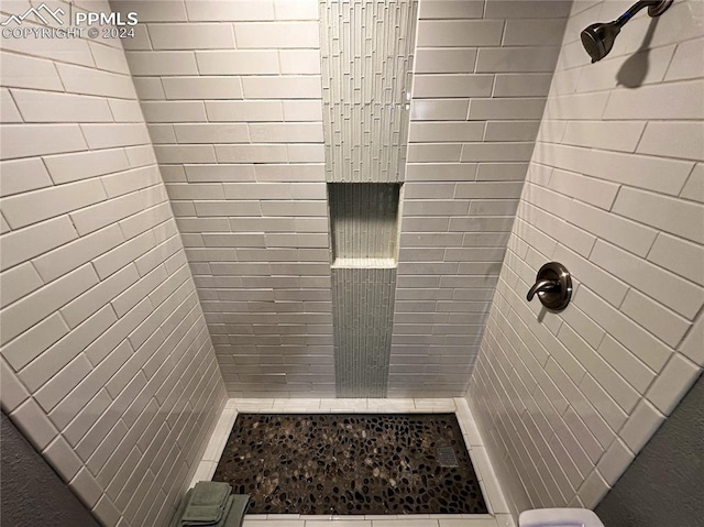 bathroom with a tile shower