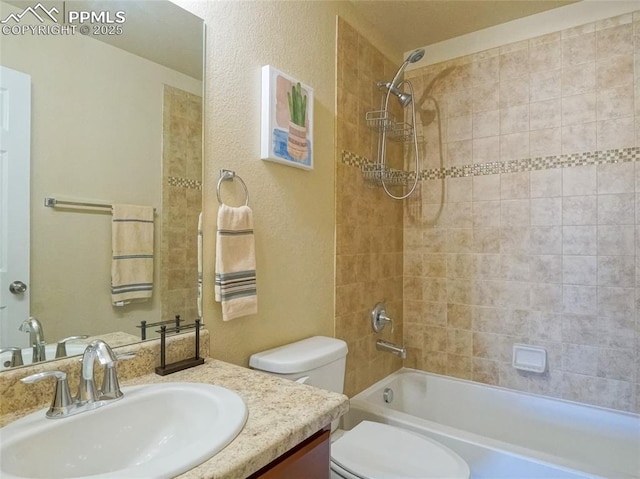 bathroom with a textured wall, vanity, toilet, and shower / bathtub combination