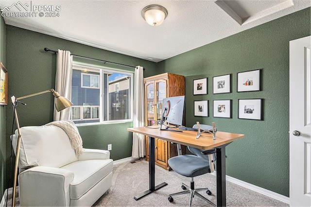 carpeted office space featuring a textured ceiling