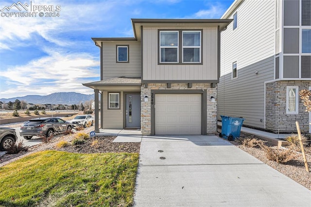 view of front of house featuring a mountain view and a garage