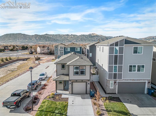 view of property with a mountain view and a garage