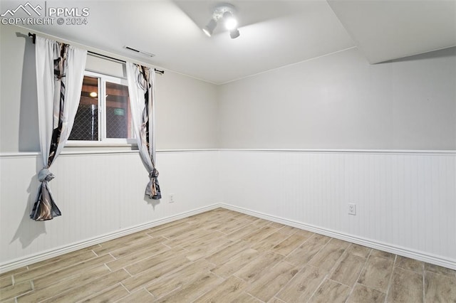 spare room with hardwood / wood-style flooring